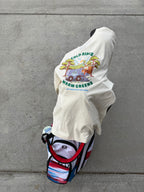 back view of long sleeve tee in the color heather natural draped over a golf bag featuring the full Fresh Sheet graphic from Putt Snipe Celly