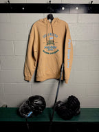 Locker Room setting featuring the Heritage design on the Sandstone colored hoodie showing both the main front design and signature word mark on left sleeve from Putt Snipe Celly.
