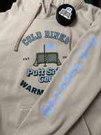 Locker Room setting featuring the Heritage design on the Smoke colored hoodie showing both the main front design and signature word mark on left sleeve from Putt Snipe Celly.